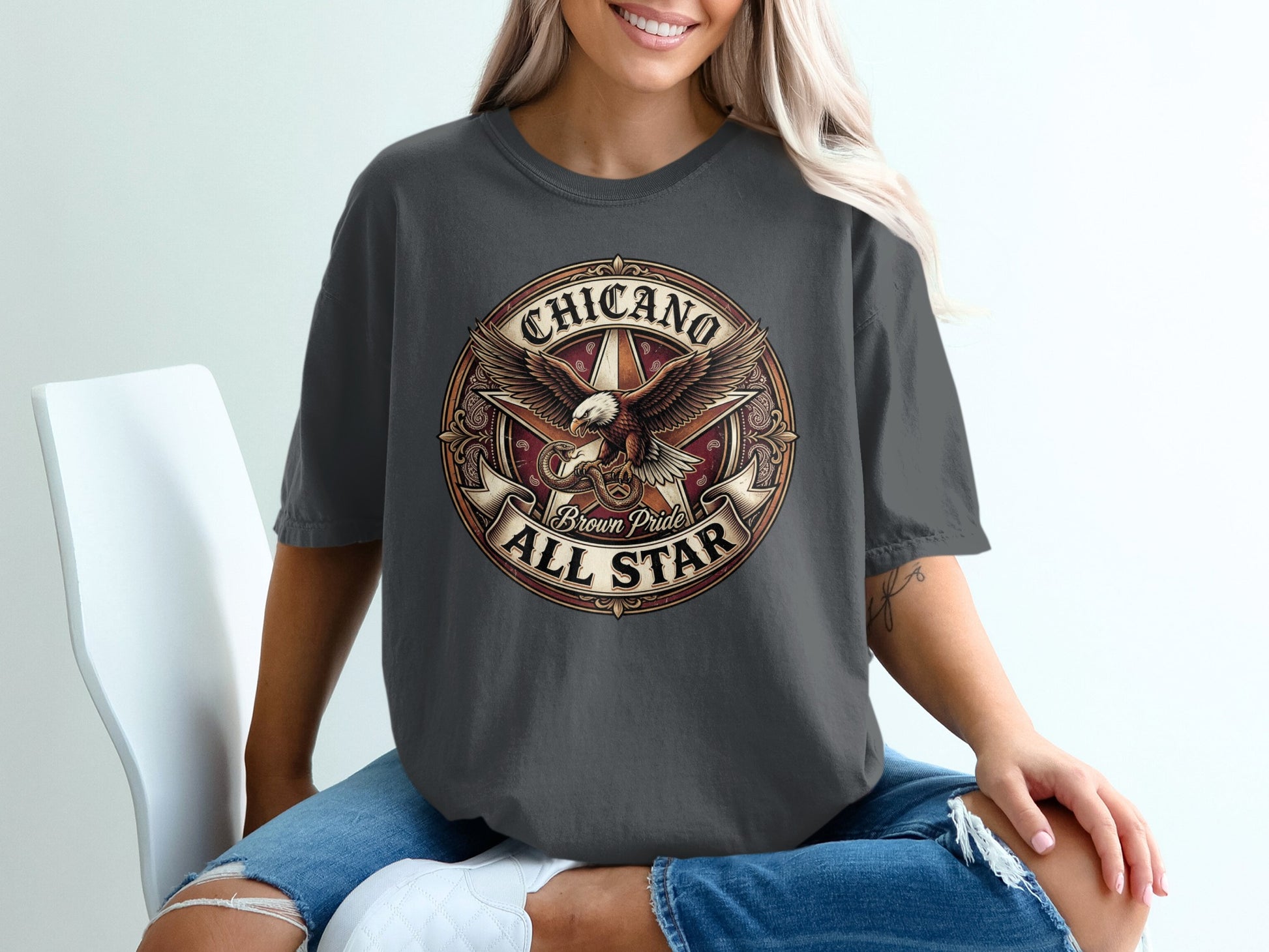 Dark gray t-shirt with "Chicano All Star Brown Pride" circular logo featuring an eagle.