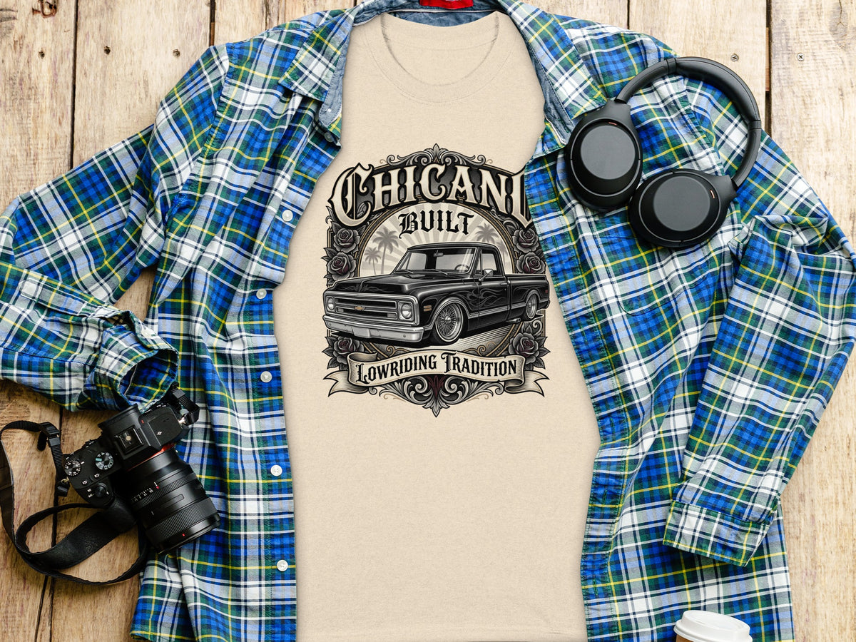 T-shirt with "Chicani Built Lowriding Tradition" graphic and a black lowrider truck.