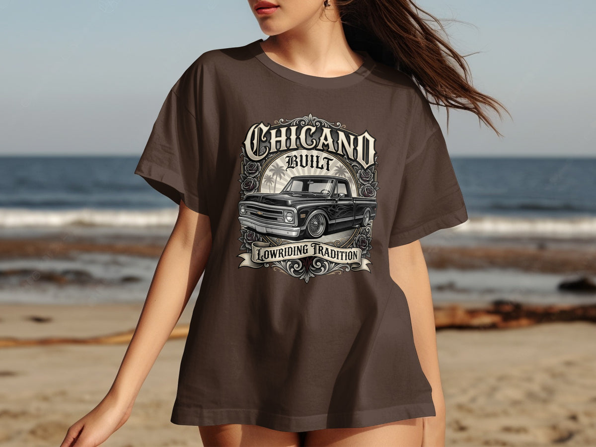 Brown t-shirt with "Chicano Built Lowriding Tradition" and classic truck graphic.