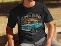 Black t-shirt with graphic of teal lowrider truck and 