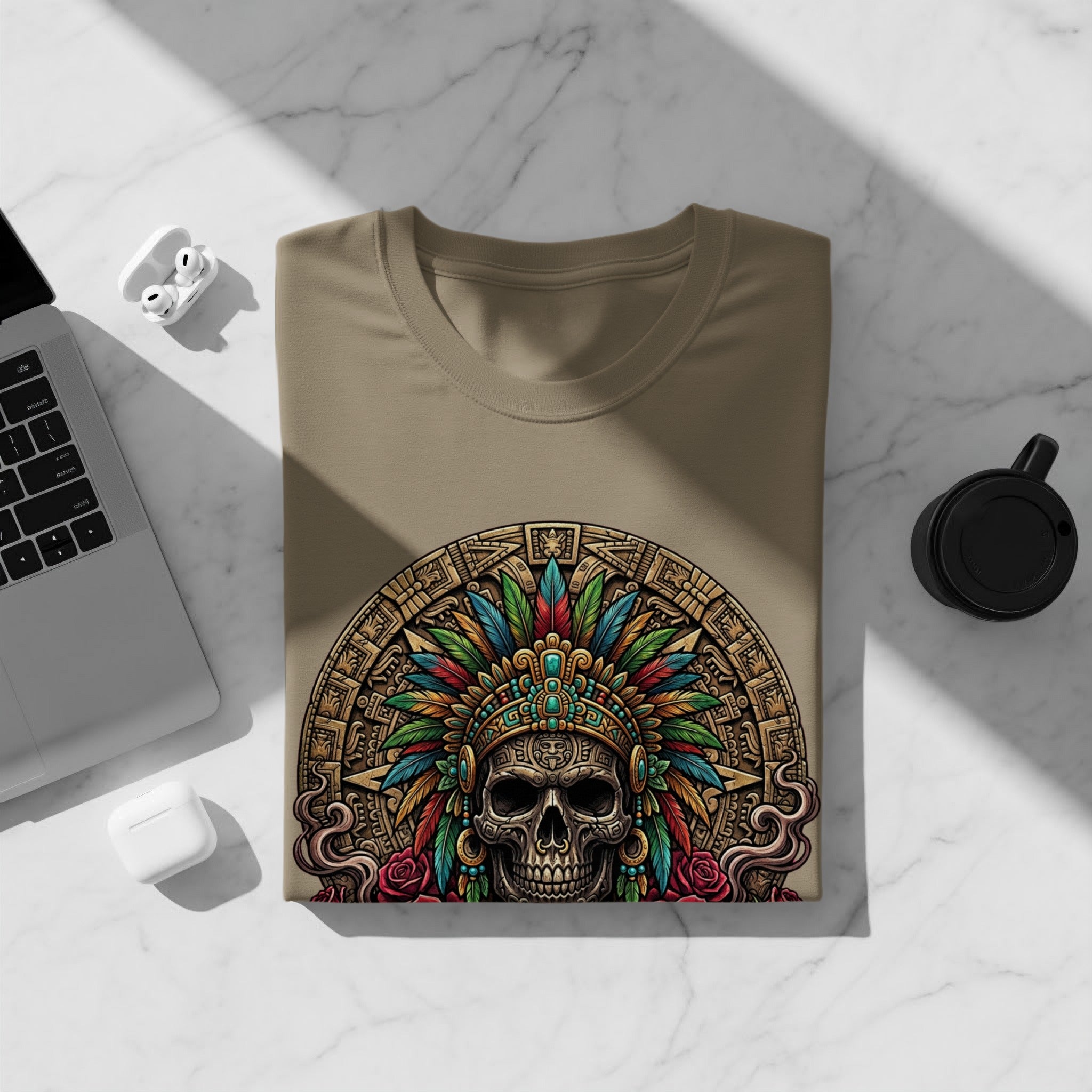 Tan t-shirt with Aztec skull and feather headdress graphic.