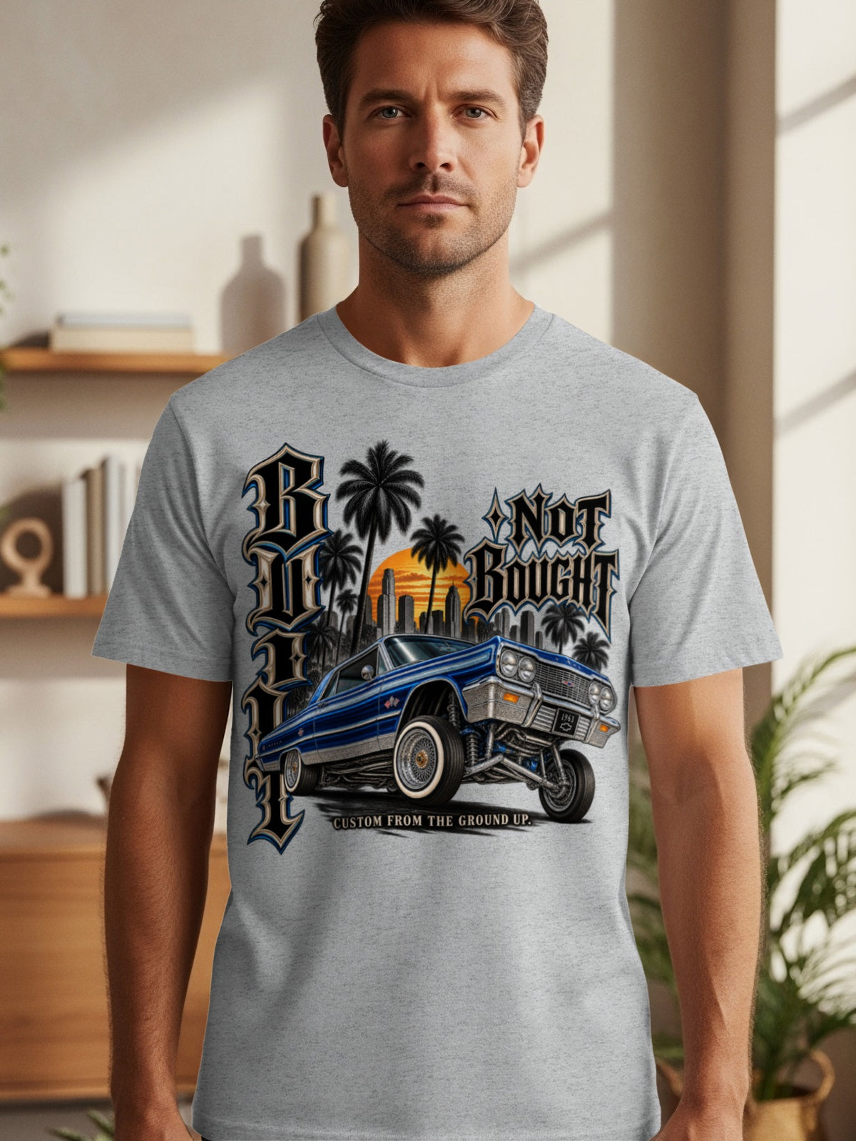 Grey t-shirt with "R Not Bought" graphic featuring a blue classic car, palm trees, and city skyline.