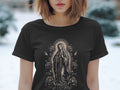 Black t-shirt with a grayscale Virgin Mary and rose graphic on the front.