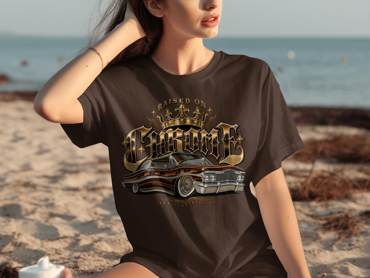Brown t-shirt with "Raised on Chrome" text, crown, and vintage lowrider car graphic.