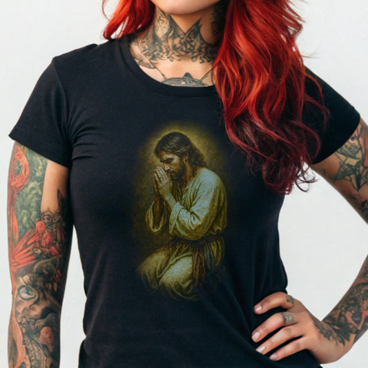 Black t-shirt with graphic of Jesus praying, kneeling with hands clasped.