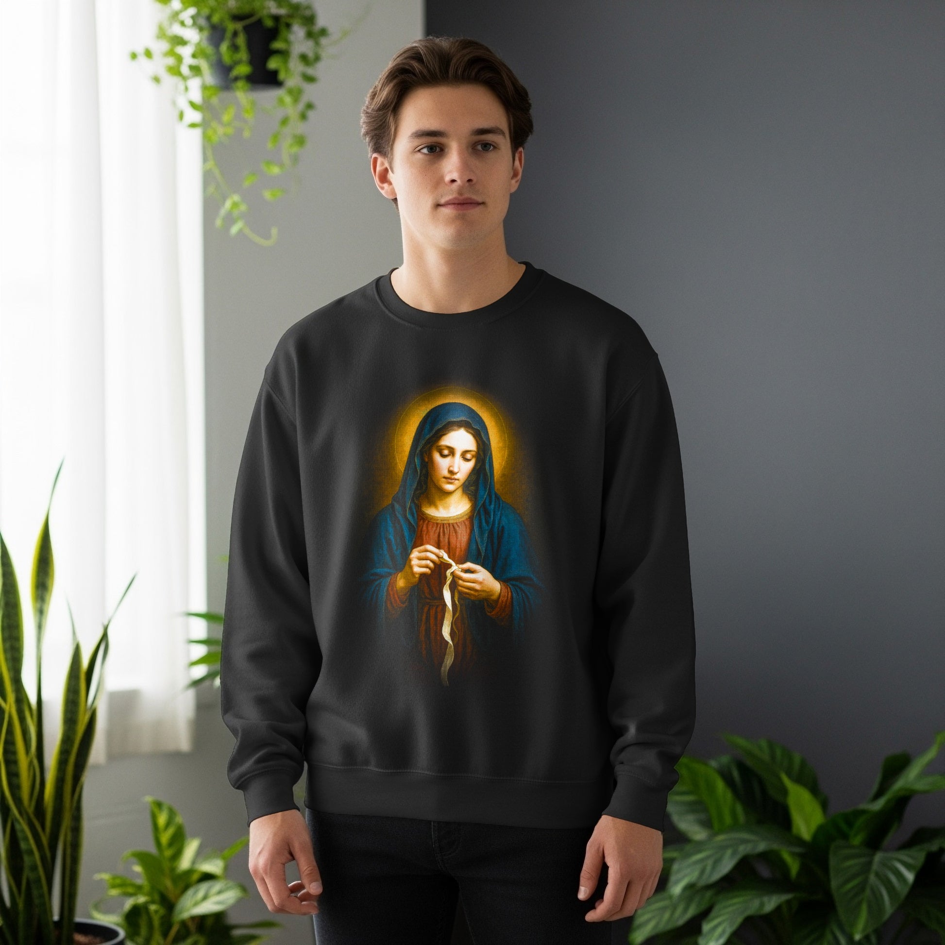 Man wearing black sweatshirt with religious depiction of Virgin Mary holding rosary.