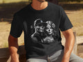 Black t-shirt with a grayscale graphic of a couple with skull-like facial makeup and floral accents.