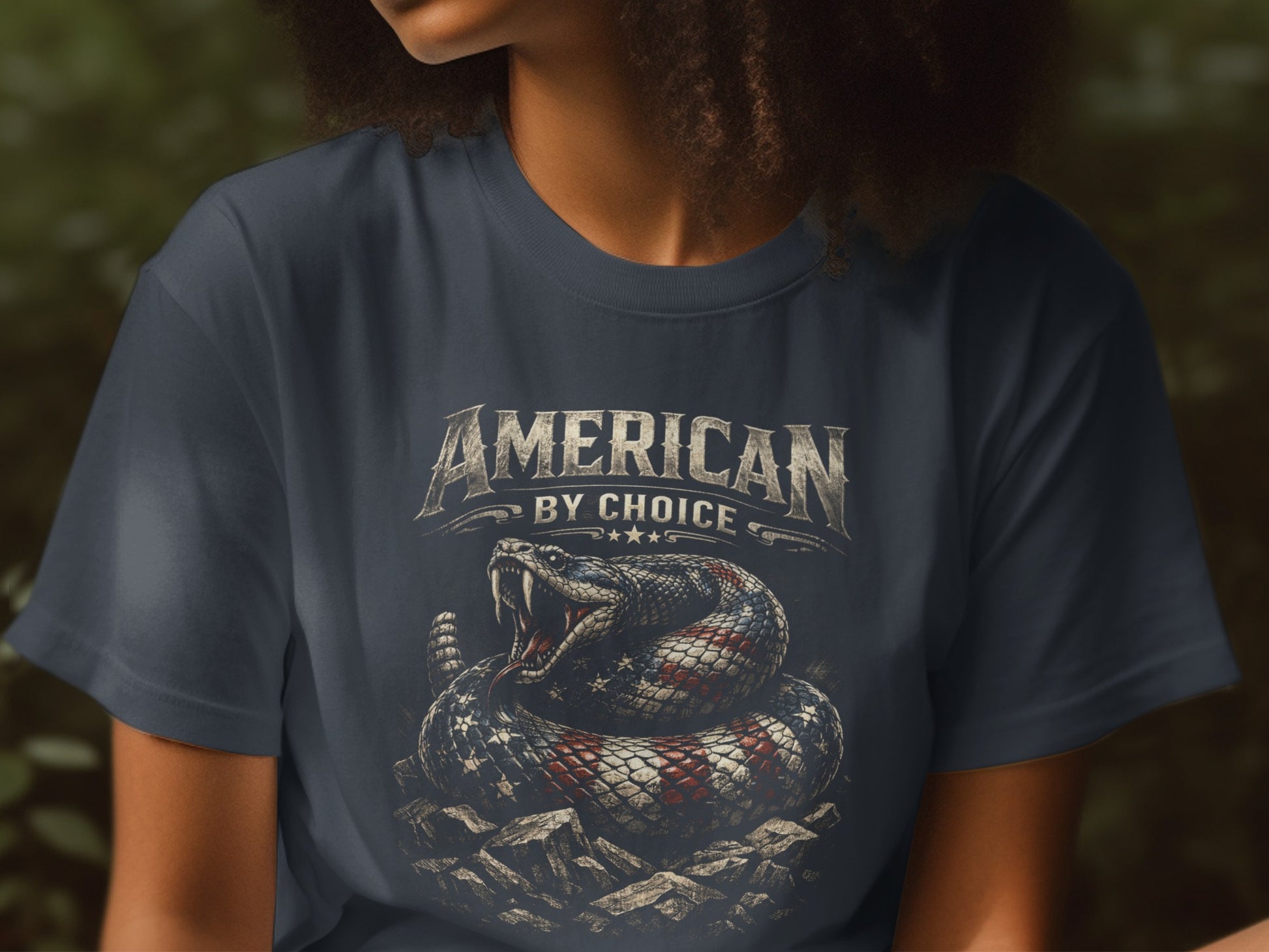 T-shirt with rattlesnake design and "American by Choice" text.