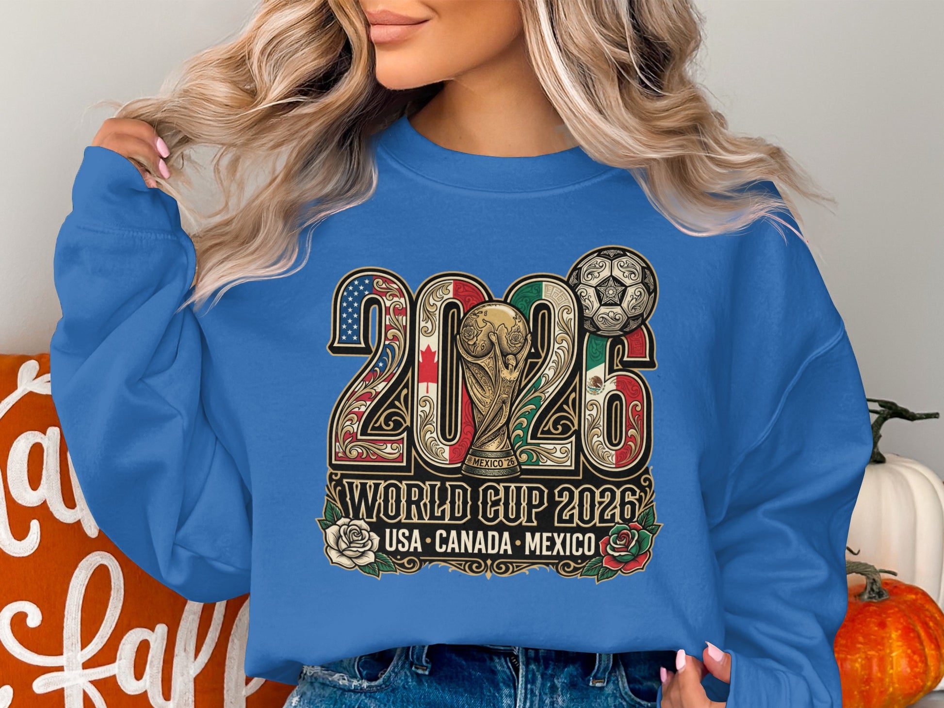Blue sweatshirt with 2026 World Cup logo, flags, and soccer ball.