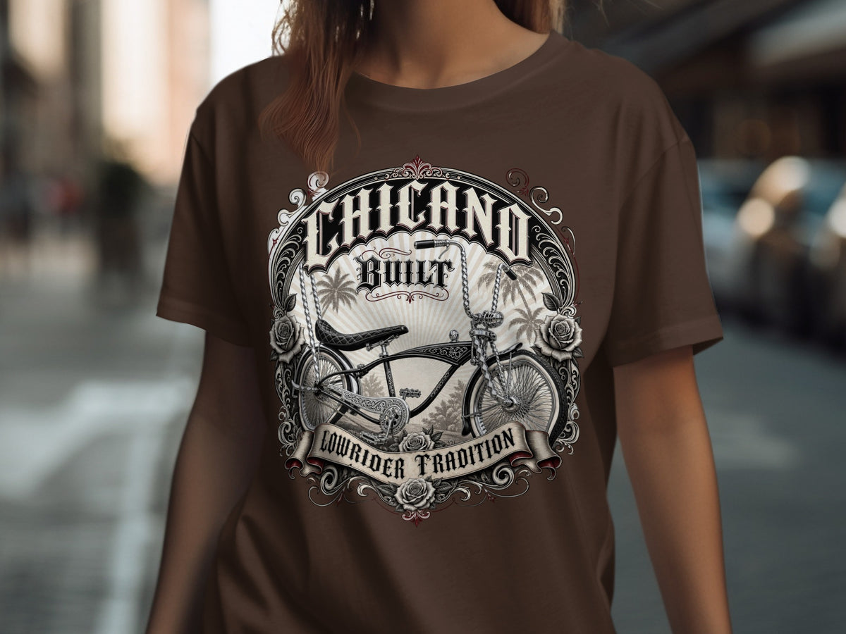 Brown t-shirt with "CHICANO BUILT LOWRIDER TRADITION" graphic featuring a vintage bicycle.