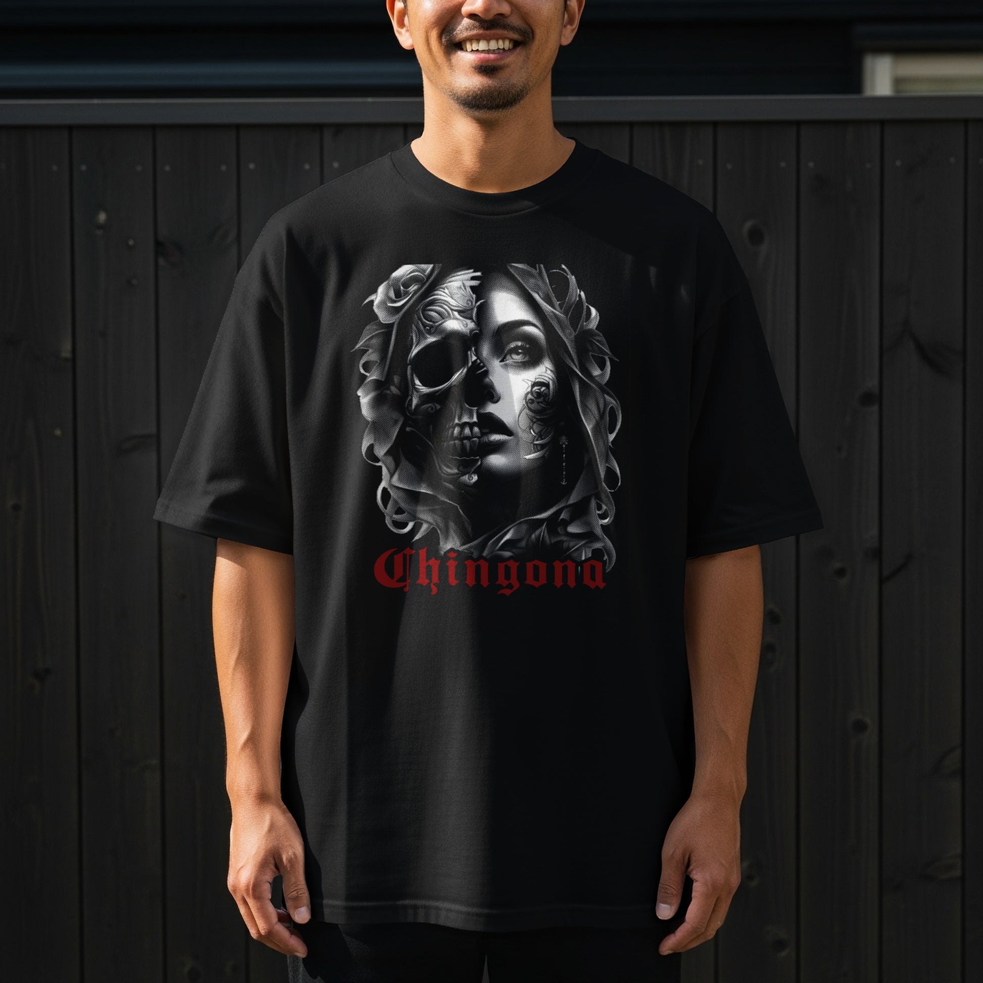Black t-shirt with a skull and floral design and "Chingona" text.