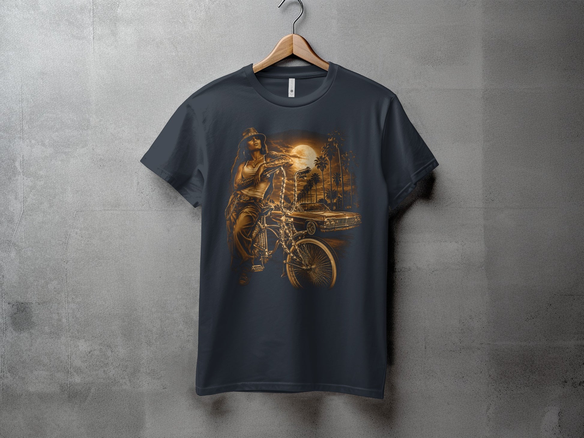 T-shirt graphic of a person on a bicycle next to a classic car under a sunset.