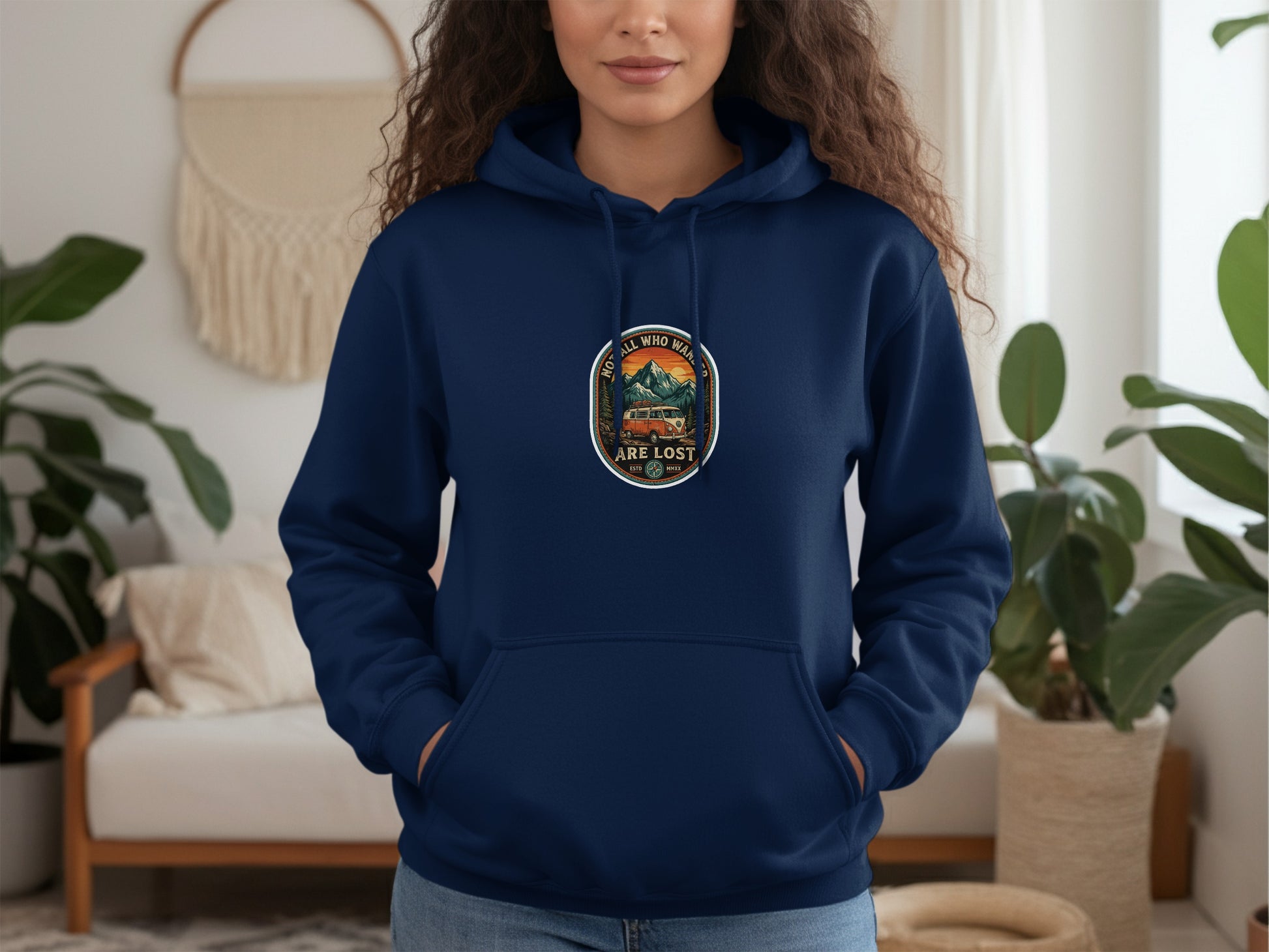 Navy hoodie with circular "Not All Who Wander Are Lost" mountain and camper van graphic.