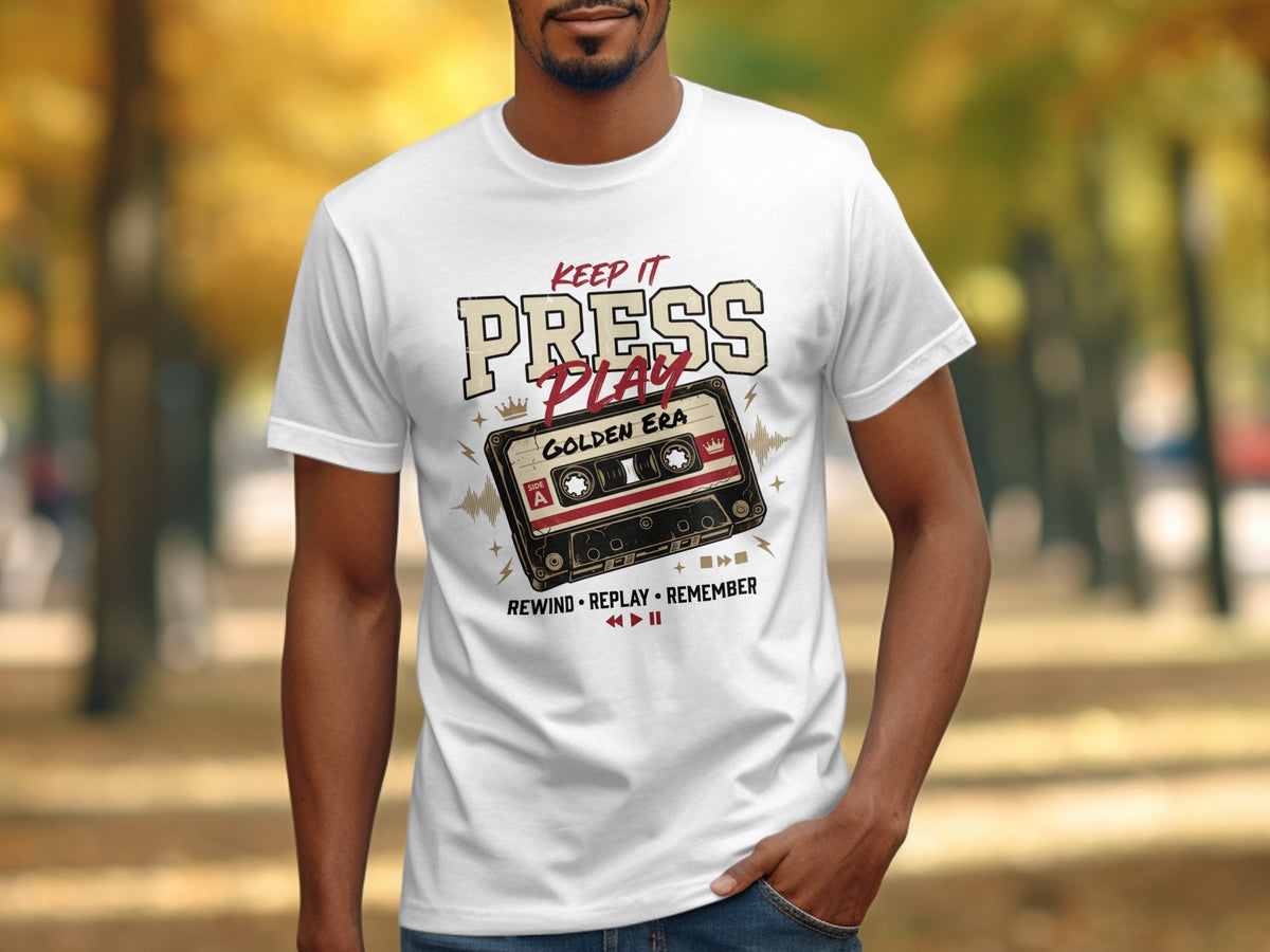 White t-shirt with "Keep It Press Play Golden Era" graphic and cassette tape.