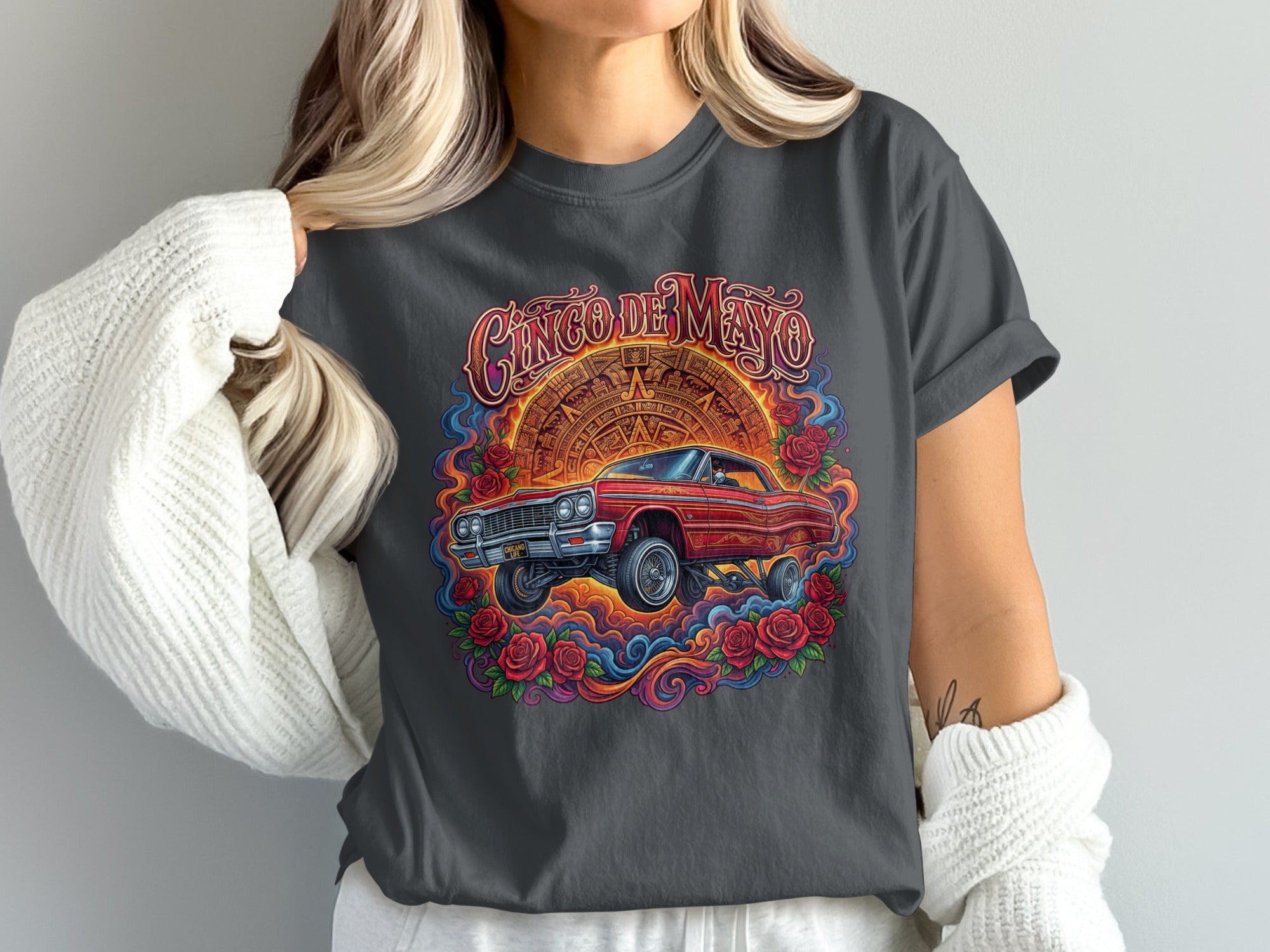 Cinco de Mayo graphic t-shirt featuring a red lowrider car surrounded by roses.