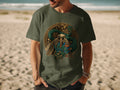 Man wearing olive green t-shirt with Aztec pyramid and feathered serpent design.