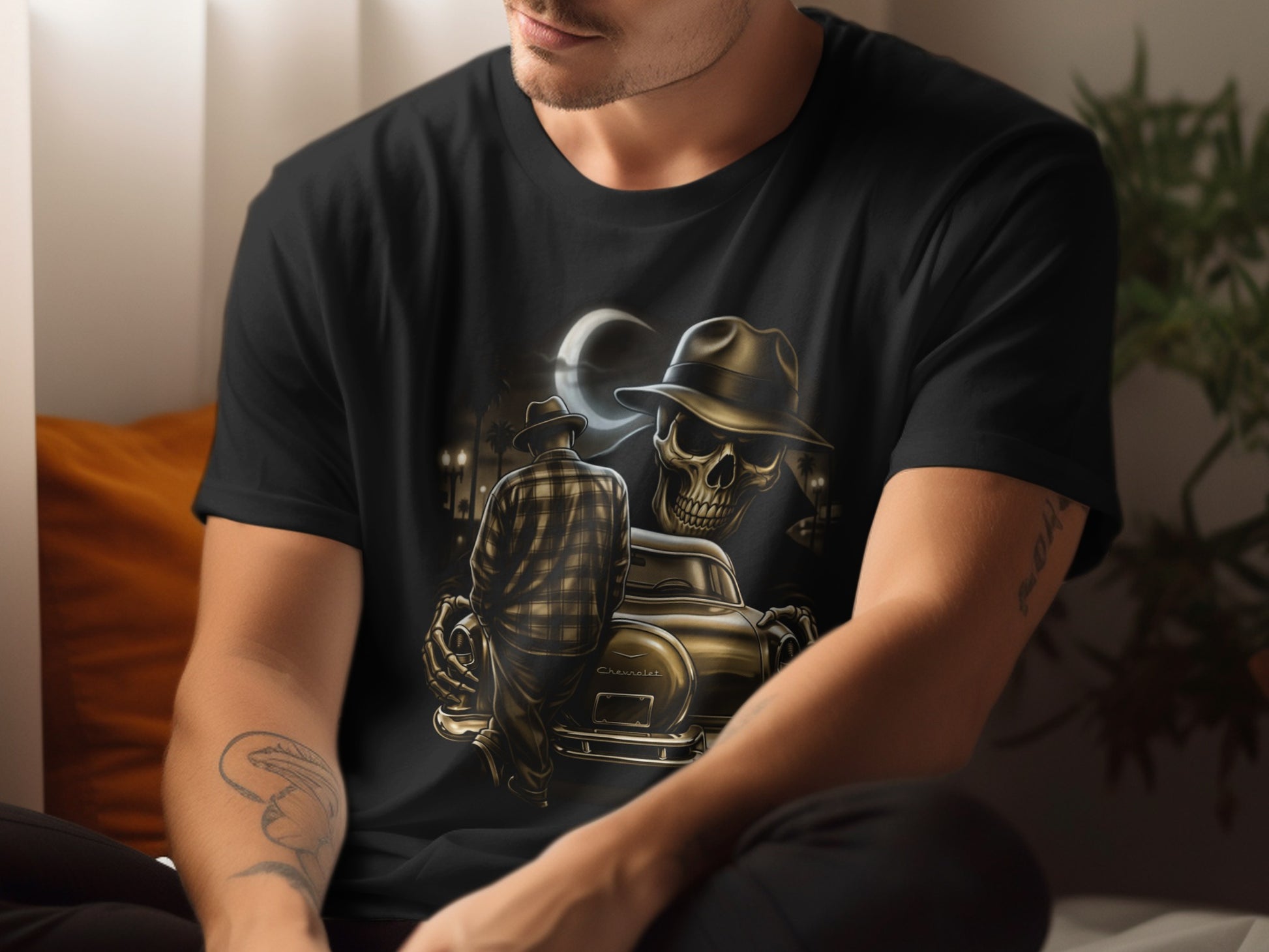 Man in t-shirt with graphic of man, fedora, and vintage car under moon.