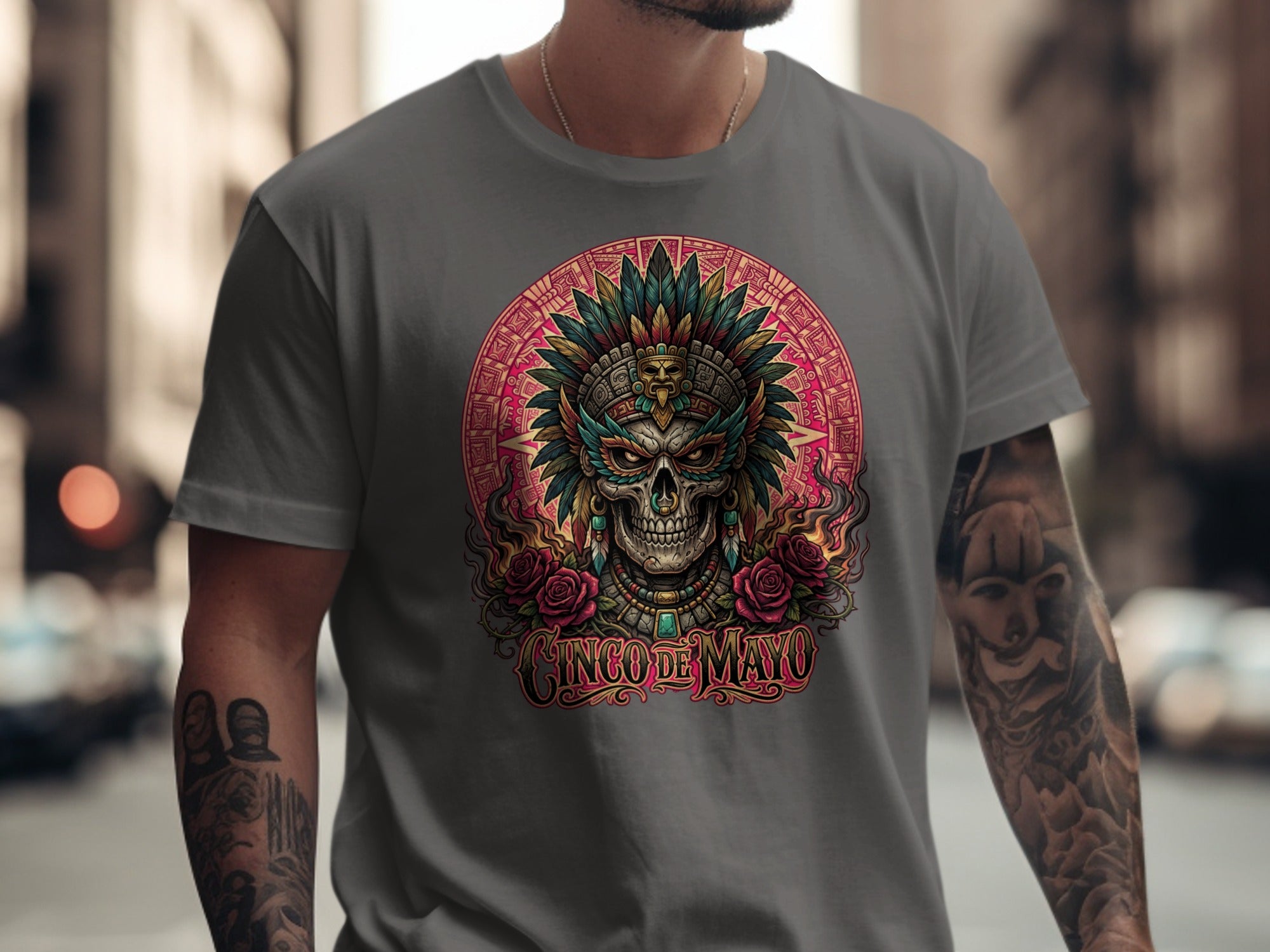 T-shirt featuring a skull with feathered headdress and roses, "Cinco de Mayo" text.