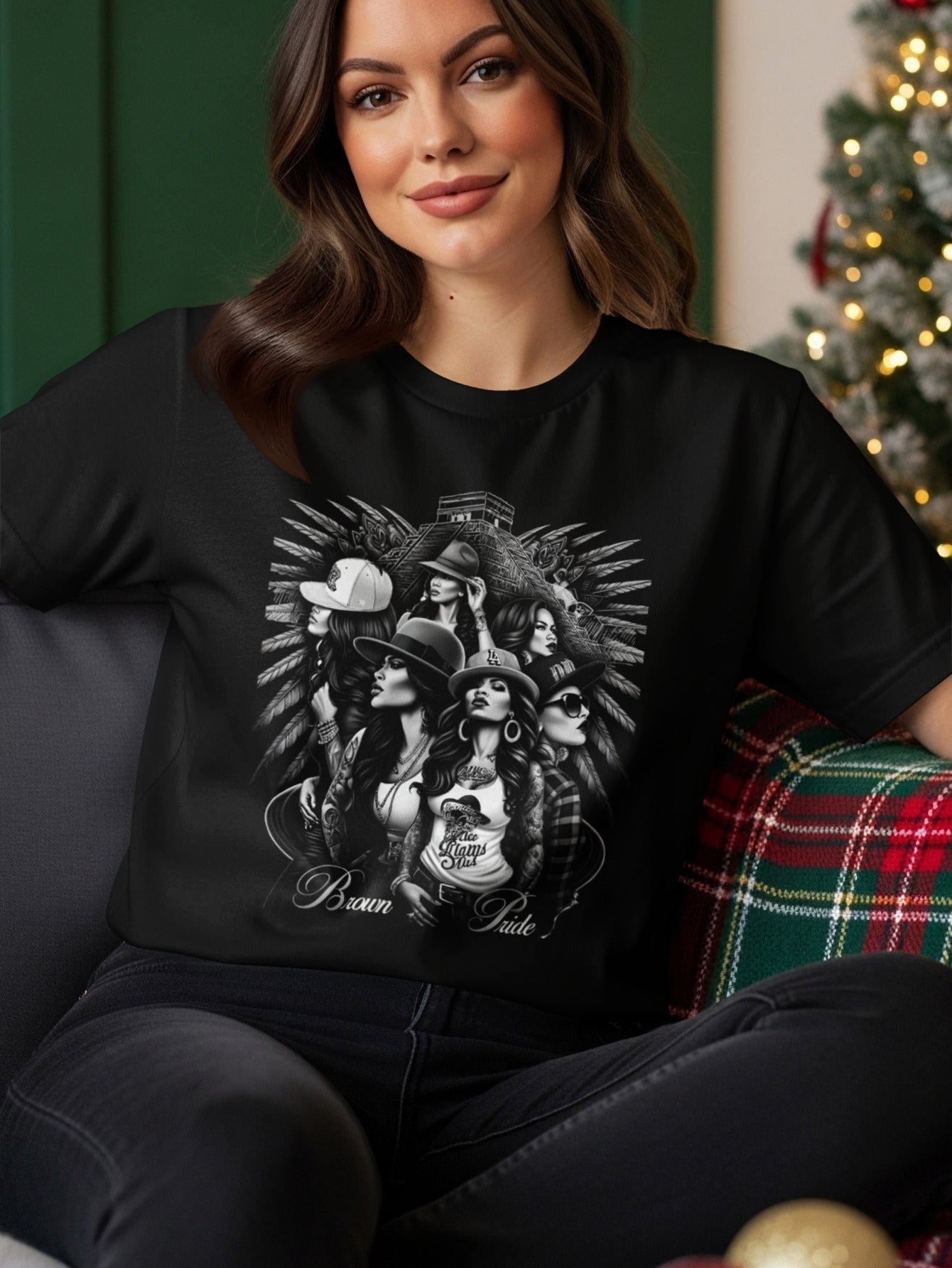Woman wearing t-shirt with graphic of women in hats, "Brown Pride" text.