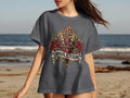 Dark grey t-shirt with graphic of heart, roses, cross, and text 