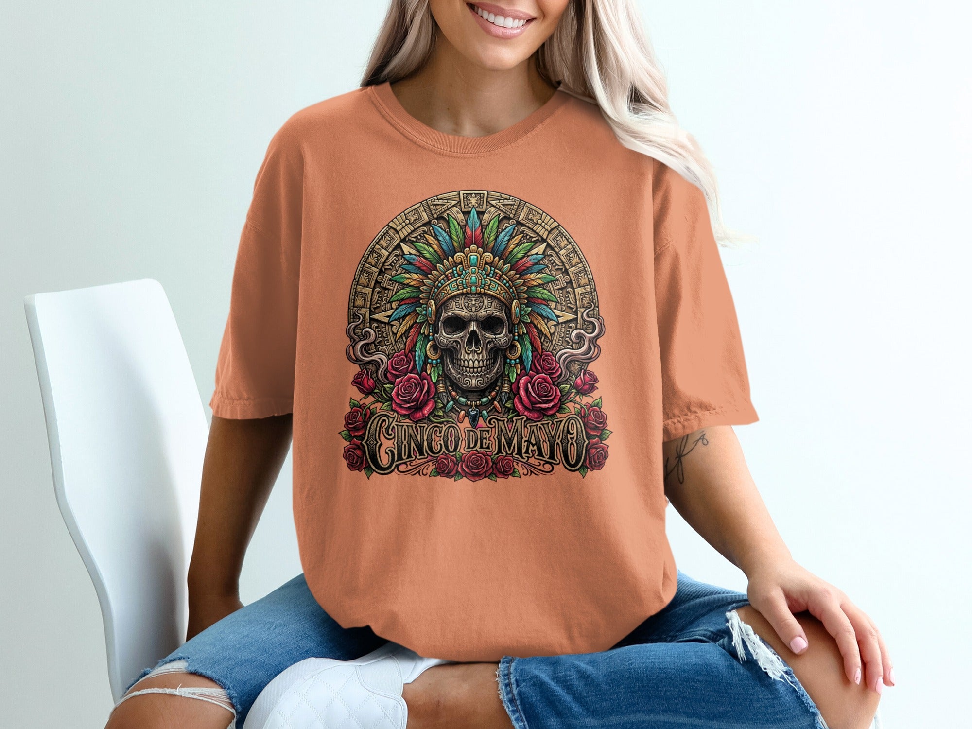 T-shirt with skull, feathers, roses, and "Cinco de Mayo" text.