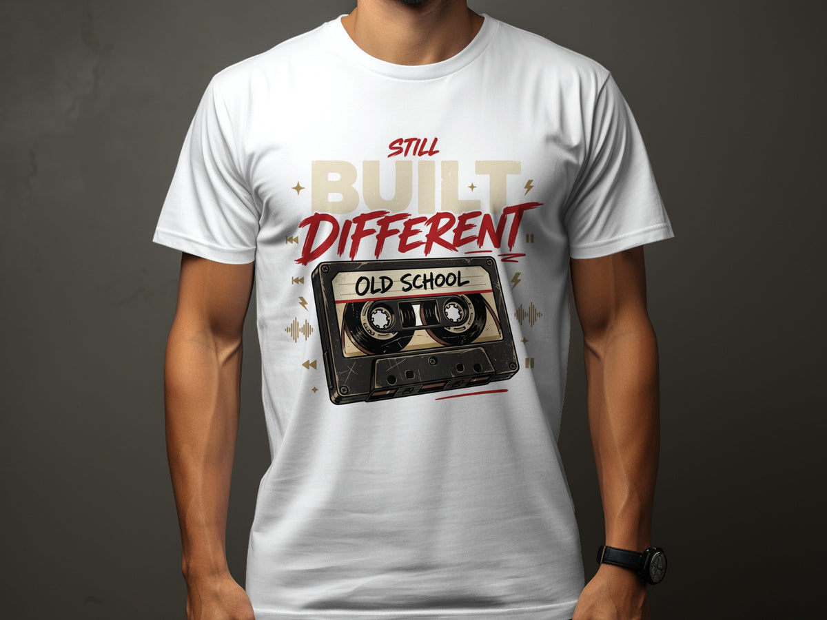 White t-shirt with "Still Built Different Old School" text and cassette tape graphic.