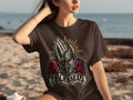 Brown t-shirt with praying hands, rosary, roses, and the word 