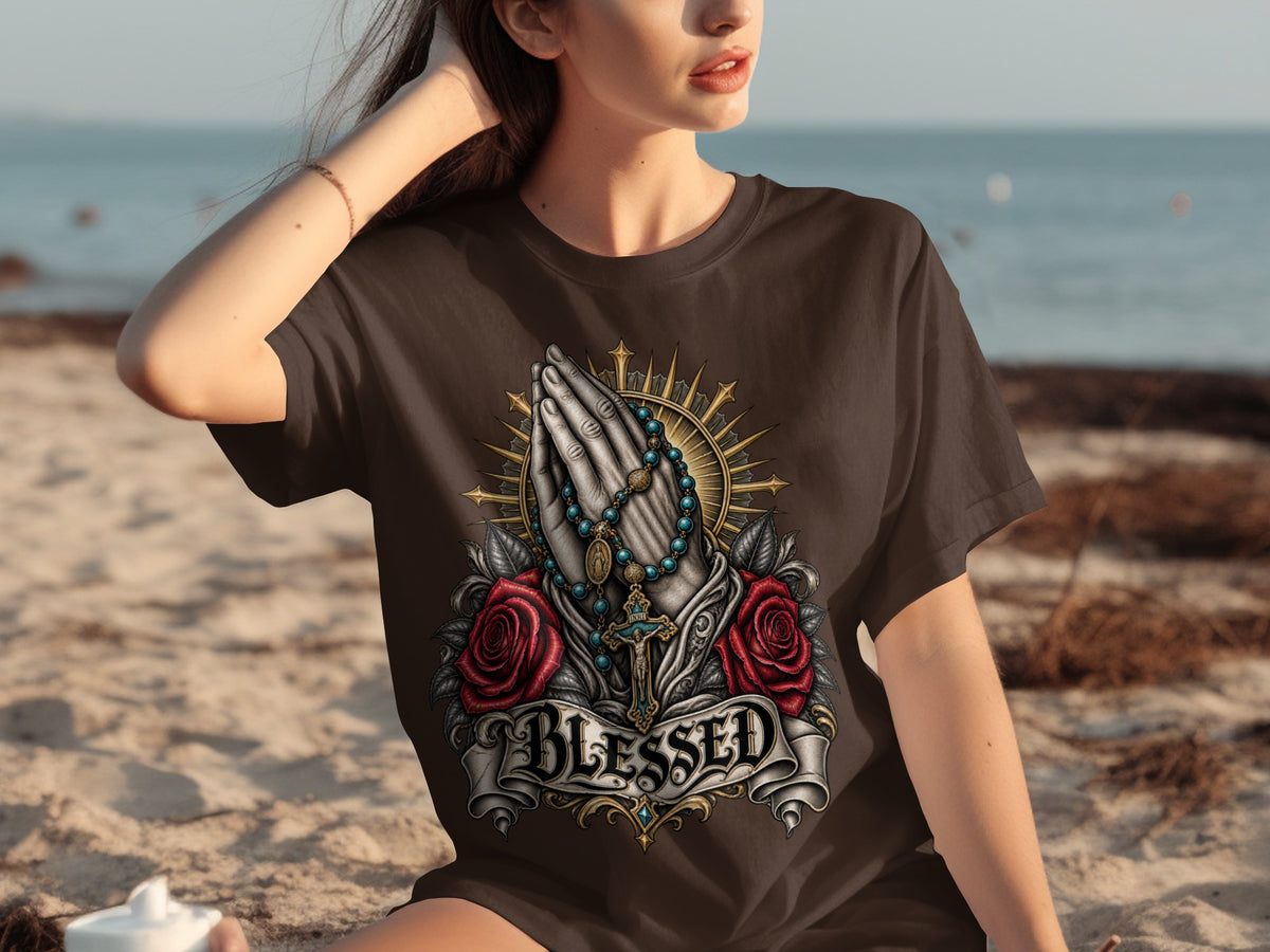 Brown t-shirt with praying hands, rosary, roses, and the word "BLESSED" graphic.