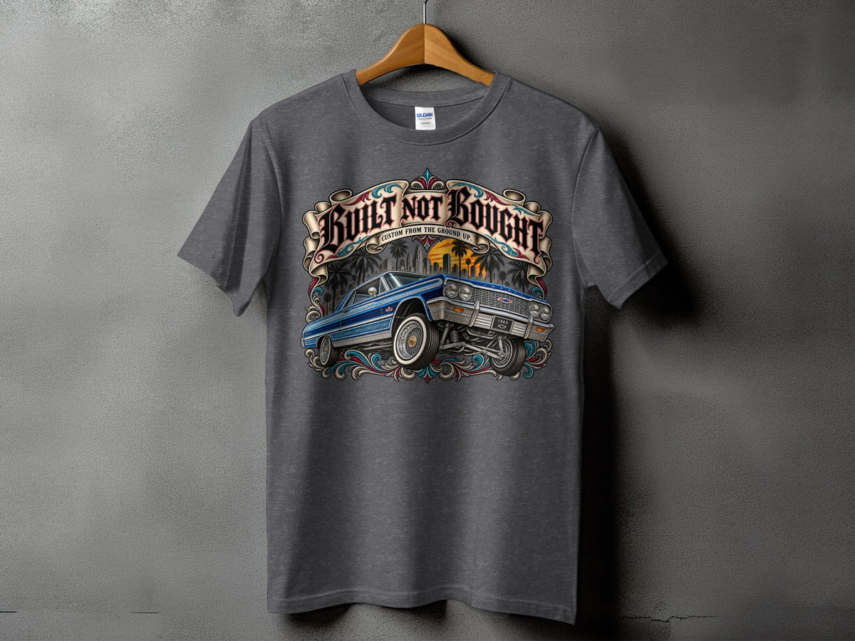 Dark grey t-shirt with "Built Not Bought" text and a classic blue lowrider car graphic.