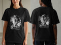 Black t-shirt with a grayscale graphic of a woman, a classic car, and floral elements.