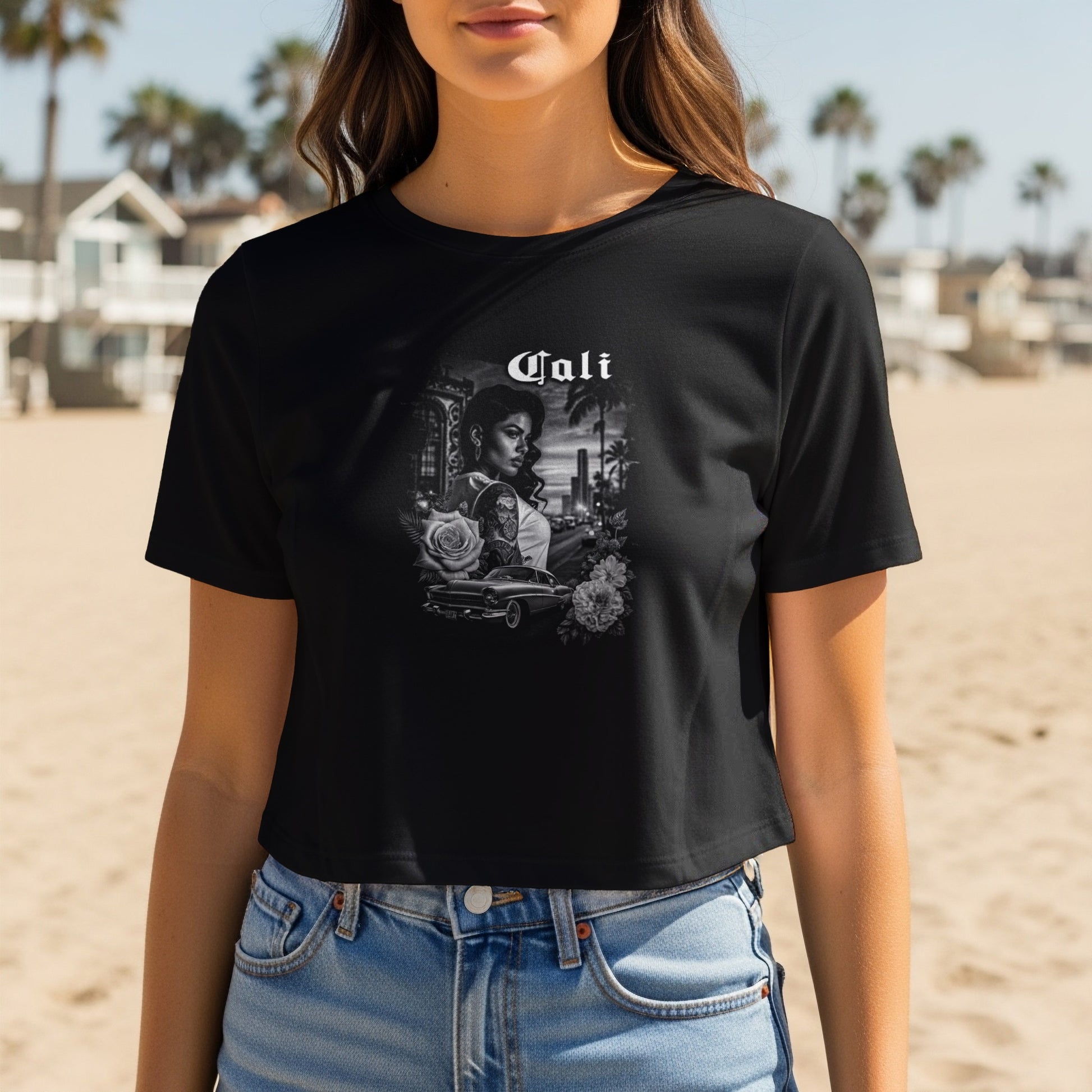 Black t-shirt with "Cali" text and a grayscale graphic of a woman, car, and cityscape.