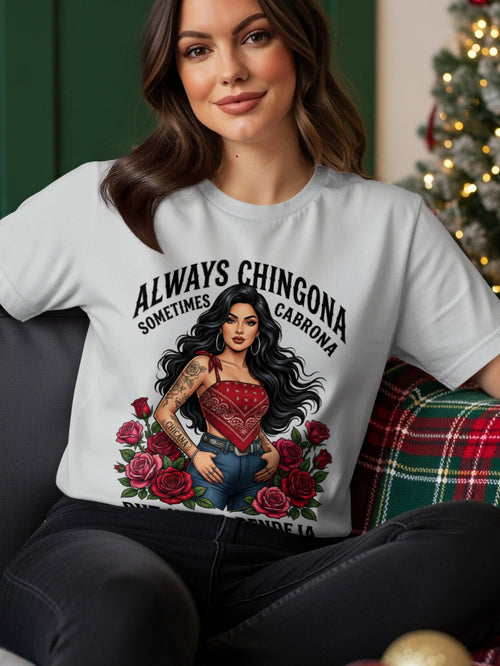 Woman wearing a t-shirt with "Always Chingona Cabrona" text and floral design.