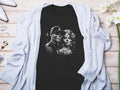 Black t-shirt with sugar skull couple graphic, Los Angeles Dodgers hat.
