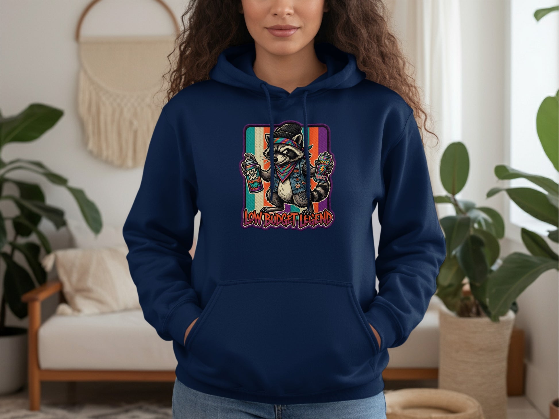 Navy hoodie featuring a raccoon wearing sunglasses and a bandana, holding spray paint cans.
