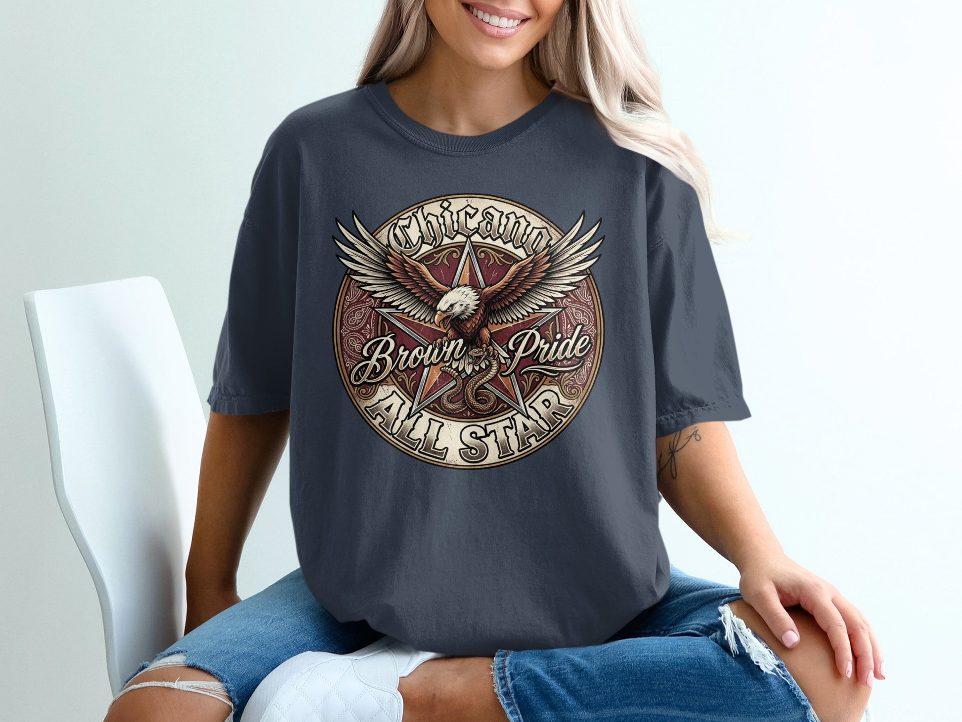 Dark grey t-shirt with a circular graphic of an eagle and "Chicano Brown Pride All Star."