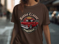 Brown t-shirt with circular design featuring red classic truck, sunset, and 