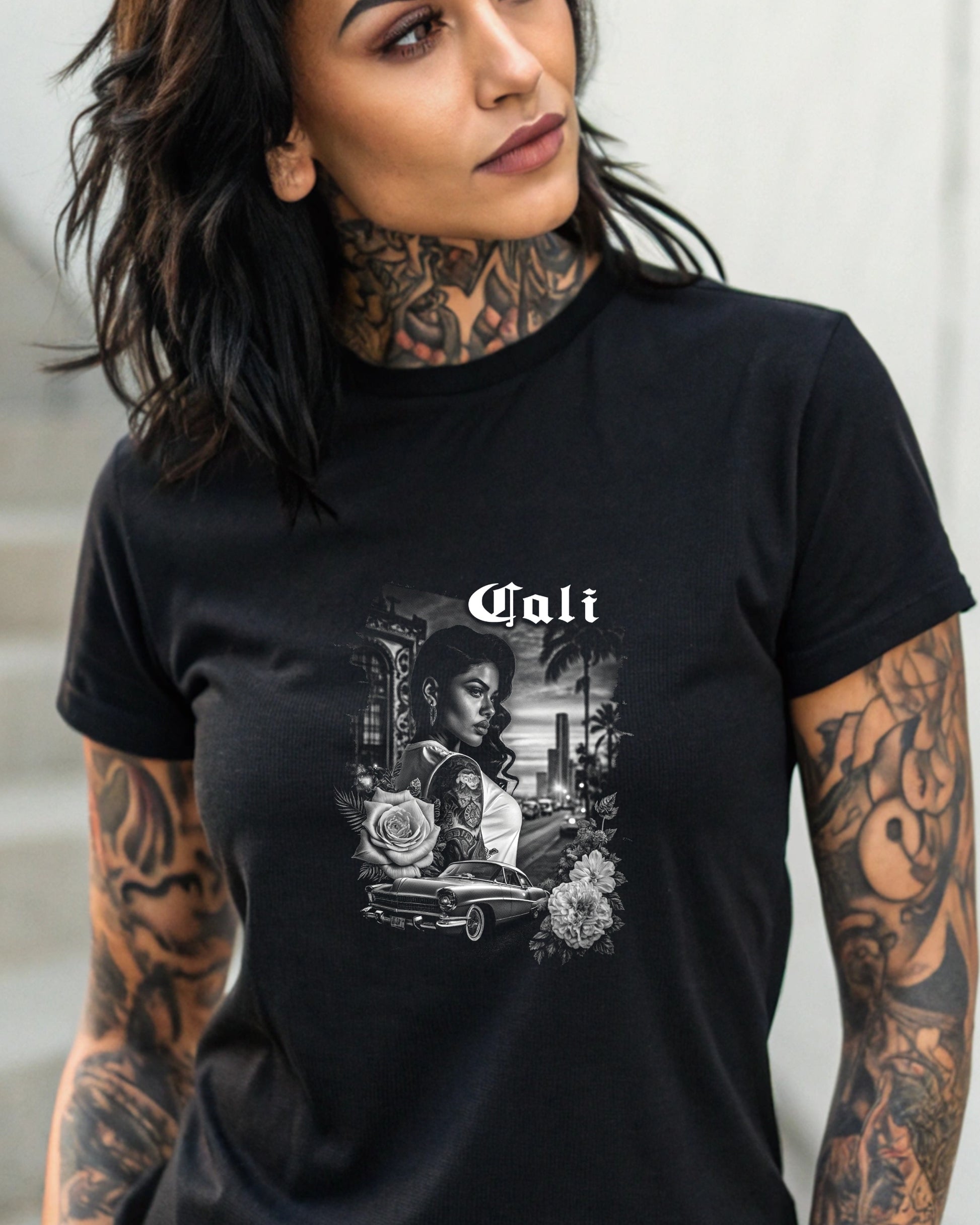 Black t-shirt with a vintage scene featuring a woman, car, and roses.