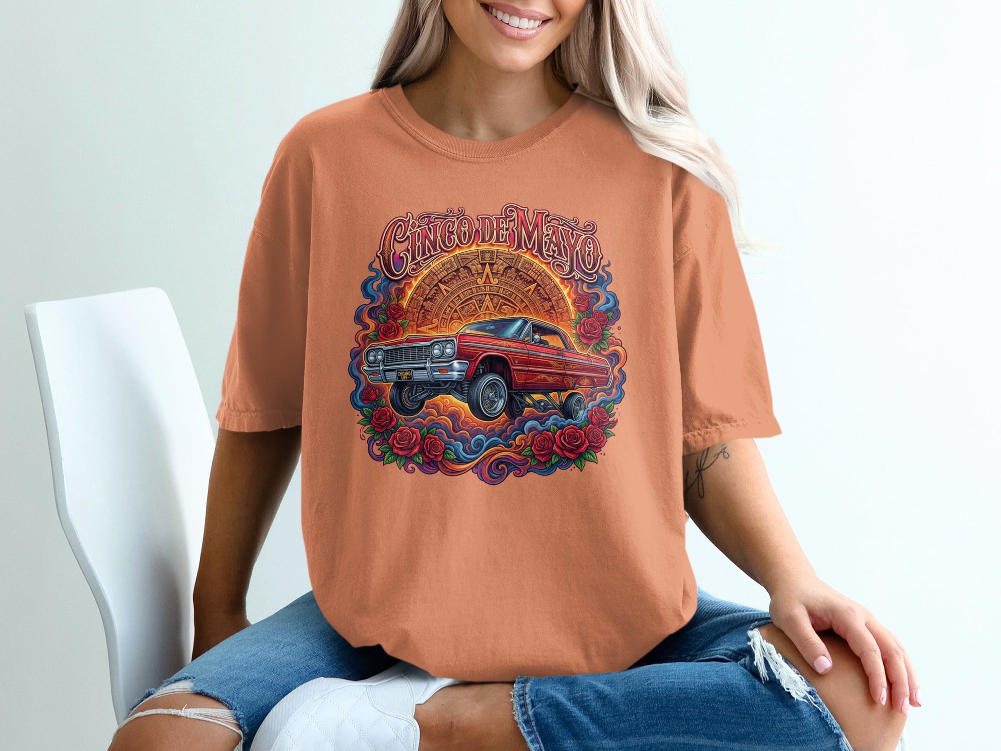 T-shirt with Cinco de Mayo graphic featuring a red lowrider and roses.