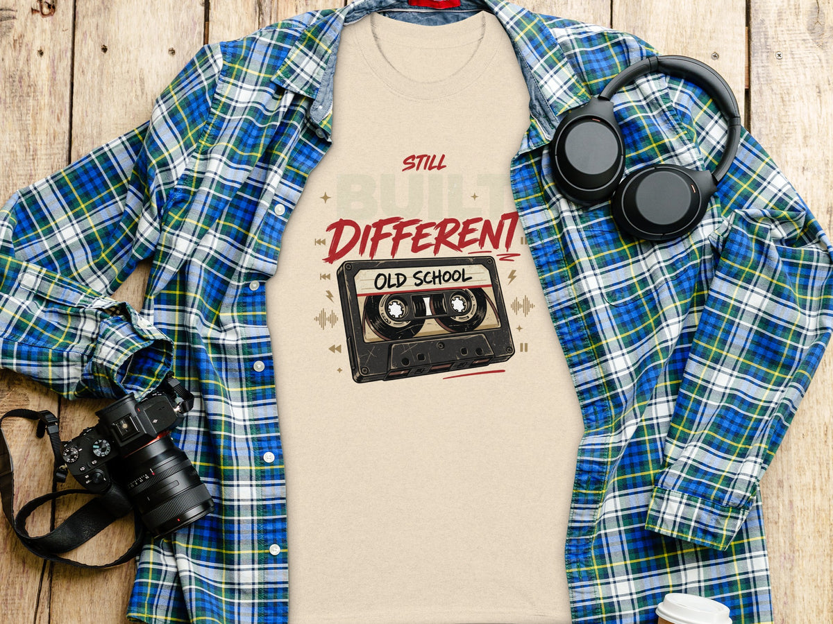 Beige t-shirt with "Still Built Different Old School" text and cassette tape graphic.