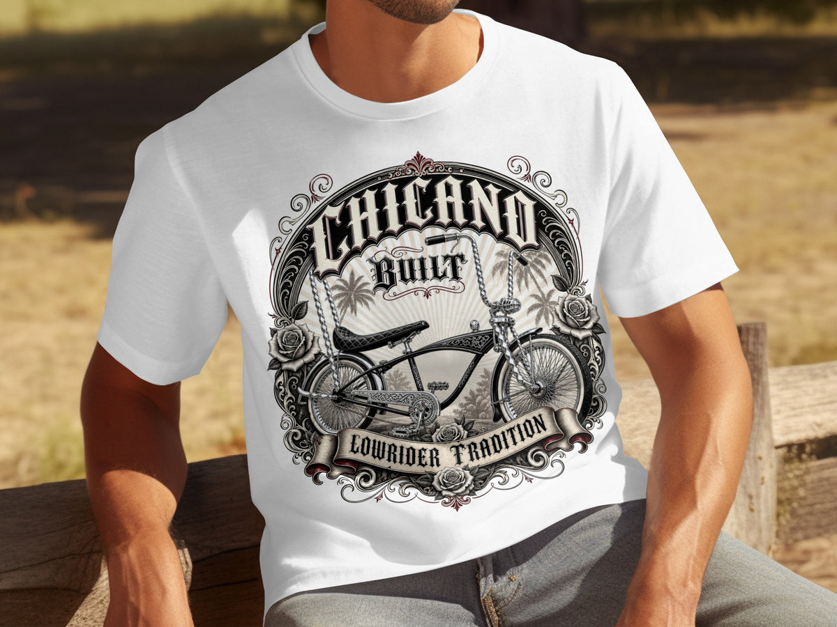 White t-shirt with "Chicano Built Lowrider Tradition" graphic and lowrider bicycle.