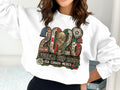 2026 FIFA World Cup USA, Canada, Mexico graphic on a white sweatshirt.