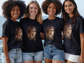 Four young women model black t-shirts with a lion's face graphic.