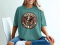Chicano Brown Pride All Star eagle and star graphic on a teal t-shirt.