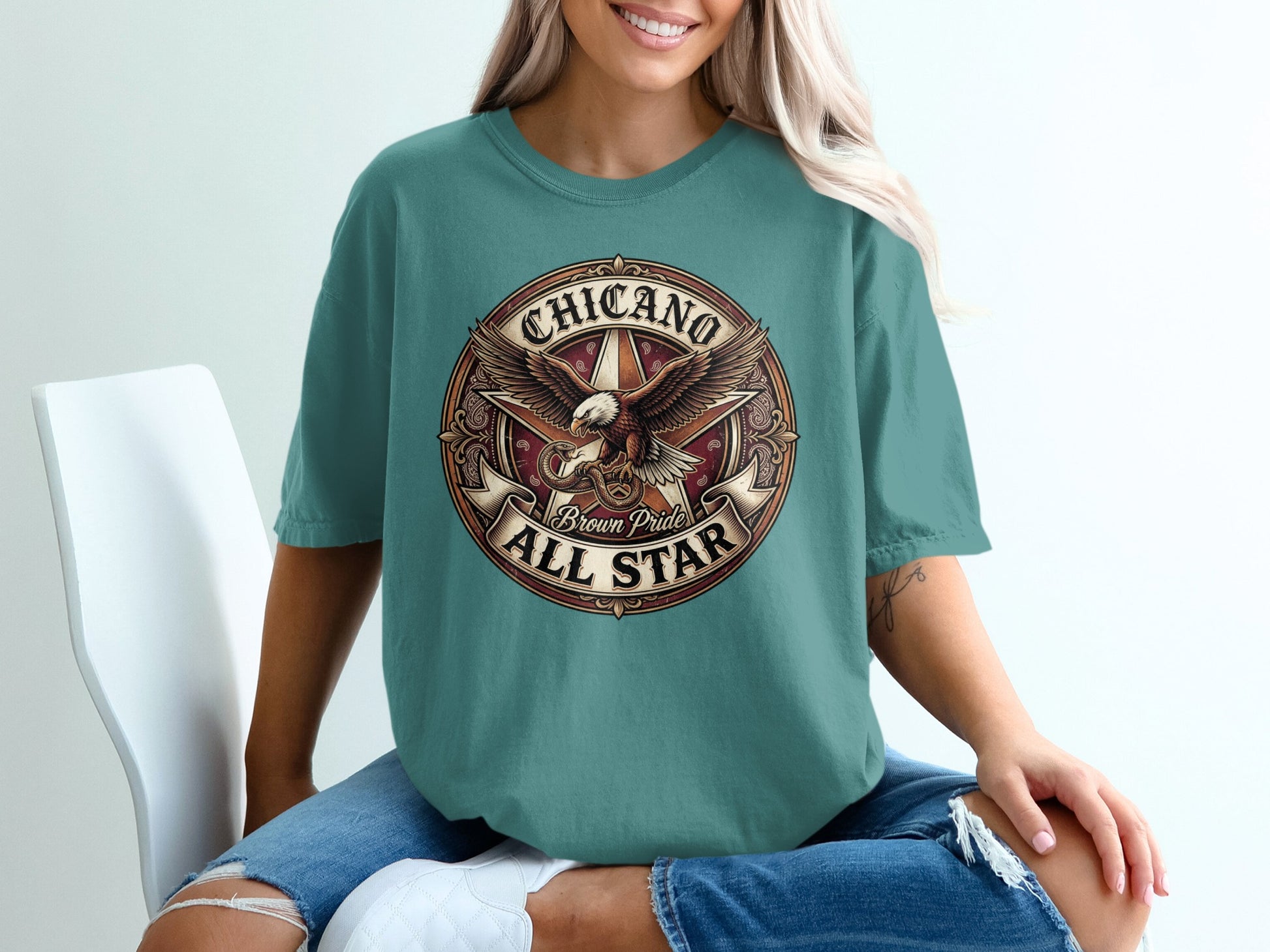 Chicano Brown Pride All Star eagle and star graphic on a teal t-shirt.