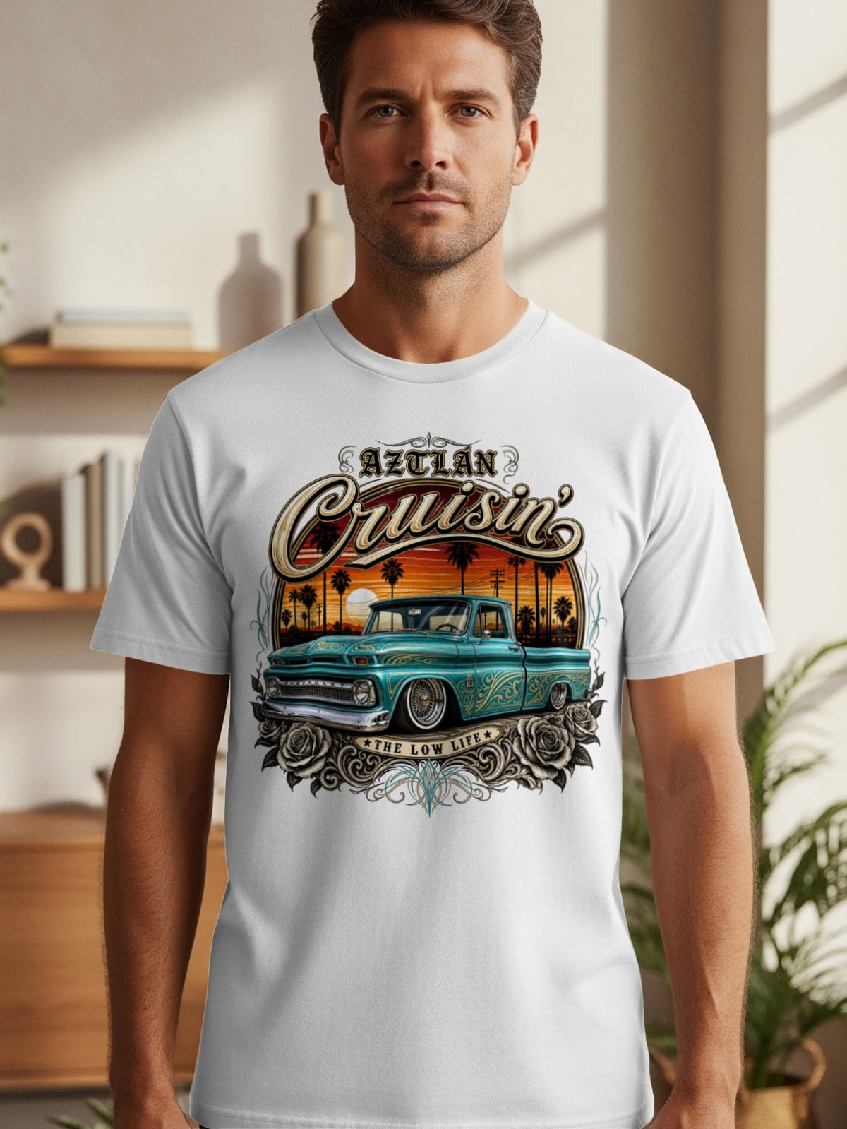 White t-shirt graphic with vintage teal truck, palm trees, sunset, and "Aztlán Cruisin'" text.