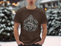 Brown t-shirt with a graphic of a heart, roses, cross, and flames with 