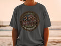 Gray t-shirt featuring a patriotic circular emblem with 