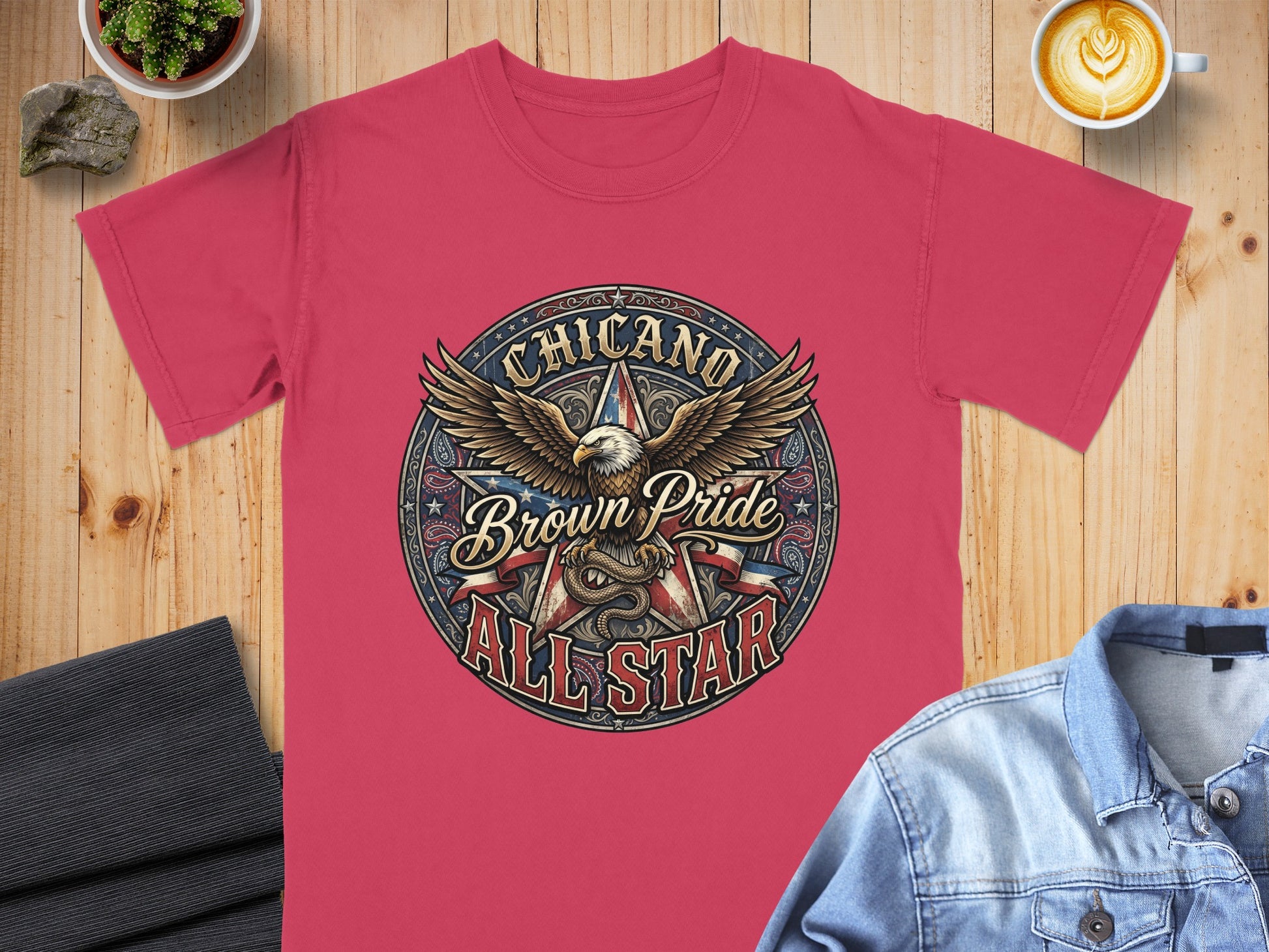 Pink t-shirt with circular "Chicano Brown Pride All Star" eagle graphic.
