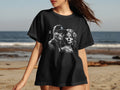 Black t-shirt with sugar skull couple design on beach background.
