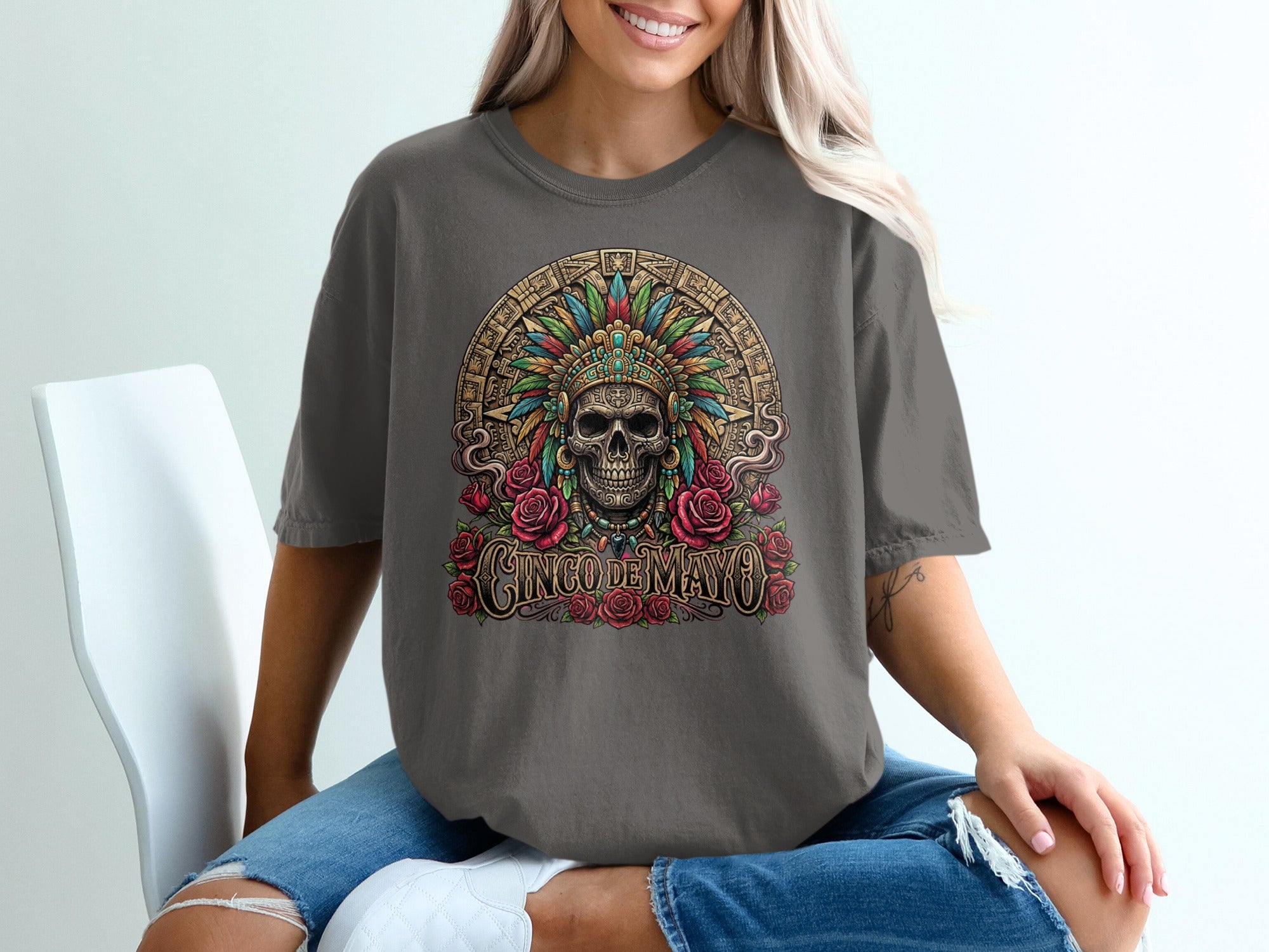 T-shirt graphic with skull wearing headdress and "Cinco de Mayo" text surrounded by roses.